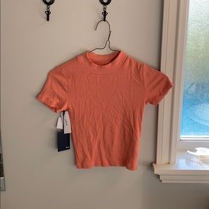a salmon pink ribbed t shirt